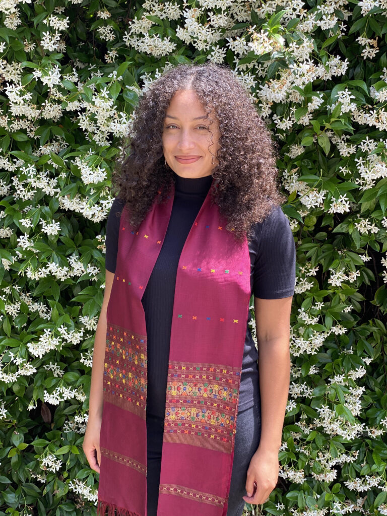 photo of Kazimir standing in front of jasmine blossoms